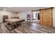 Spacious finished basement featuring a pool table, dart board, and rustic barn door at 1415 Isabell St, Golden, CO 80401
