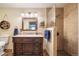 Updated bathroom featuring a walk-in shower, vanity with drawers, and decorative mirror at 1415 Isabell St, Golden, CO 80401