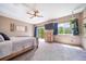 Comfortable bedroom with ceiling fan, television, outside access, and natural light from multiple windows at 1415 Isabell St, Golden, CO 80401