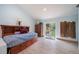 Comfortable bedroom features built-in storage, wood accent wall, and a sliding glass door to the backyard at 1415 Isabell St, Golden, CO 80401
