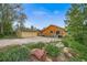 Exterior view of the home showing the wood exterior, a two-car garage, and the surrounding greenery at 1415 Isabell St, Golden, CO 80401