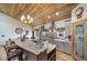 Kitchen featuring wood ceiling, granite countertops, modern appliances, and a center island at 1415 Isabell St, Golden, CO 80401