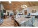 Island kitchen with stainless appliances, custom cabinetry, wooden ceiling, and granite countertops at 1415 Isabell St, Golden, CO 80401