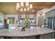 Kitchen featuring wood ceiling, granite countertops, modern appliances, and a center island at 1415 Isabell St, Golden, CO 80401