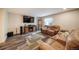 Cozy living room with large leather seating, a modern entertainment center, and a patterned rug at 1415 Isabell St, Golden, CO 80401