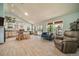 Open-concept living area with tile floors, a kitchen island, and multiple seating areas at 1415 Isabell St, Golden, CO 80401