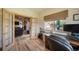 Home office featuring built-in desk, outdoor views, and living room access through glass French doors at 1415 Isabell St, Golden, CO 80401