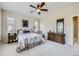 Well-lit bedroom with an ornate dresser, comfortable furnishings, and a ceiling fan at 12930 Bobcat Ct, Broomfield, CO 80021