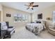 Comfortable bedroom featuring a ceiling fan and large windows with natural light at 12930 Bobcat Ct, Broomfield, CO 80021
