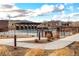 Community pool with stone detailing and landscaping against mountain backdrop at 12930 Bobcat Ct, Broomfield, CO 80021