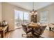 Bright dining area featuring a unique table, stylish decor, and access to the outside patio at 12930 Bobcat Ct, Broomfield, CO 80021