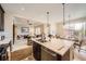 Open-concept kitchen with a breakfast bar, seamlessly connecting to the living and dining areas at 12930 Bobcat Ct, Broomfield, CO 80021