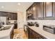 Beautiful kitchen with dark wood cabinets, stainless steel appliances, and light countertops at 12930 Bobcat Ct, Broomfield, CO 80021