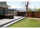 A backyard features a gray deck, lawn, privacy fence, hot tub, and partial mountain view at 1008 Park View Ct, Castle Rock, CO 80104