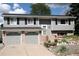 Charming home with a two-car garage, gray siding and landscaped front yard at 1008 Park View Ct, Castle Rock, CO 80104