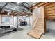 Unfinished basement area featuring the laundry area, exposed ceiling and stairwell to the upper floor at 3748 Oakwood Dr, Longmont, CO 80503
