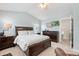 Bedroom with a dark wooden bed set, TV, vaulted ceiling, and two windows allowing for lots of natural light at 3748 Oakwood Dr, Longmont, CO 80503