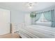 Light and airy bedroom featuring a ceiling fan, mounted television, and a comfy bed with neutral-toned bedding at 3748 Oakwood Dr, Longmont, CO 80503