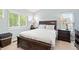 This bedroom is equipped with dual windows for lots of light and a dark, low profile platform bed and side tables at 3748 Oakwood Dr, Longmont, CO 80503