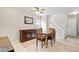 Well-lit dining room features a classic wooden table, complemented by neutral walls and a stairway at 3748 Oakwood Dr, Longmont, CO 80503