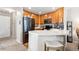 Functional kitchen with wooden cabinets, stainless steel appliances, and a practical breakfast bar at 3748 Oakwood Dr, Longmont, CO 80503