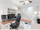 Office space with built-in desk and cabinets, featuring a carpeted stairway at 3748 Oakwood Dr, Longmont, CO 80503