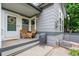 Inviting front porch featuring a cozy seating area with wicker chairs and a grill, creating a welcoming outdoor space at 3748 Oakwood Dr, Longmont, CO 80503