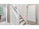 Carpeted stairway features a white banister and access to an upstairs room at 3748 Oakwood Dr, Longmont, CO 80503