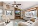 Cozy living room featuring a modern fireplace, large windows, and comfortable seating at 13298 Alcott Cir, Broomfield, CO 80020