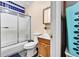 Functional bathroom with shower-tub combo, updated vanity, and classic blue tile at 7060 Holly St, Commerce City, CO 80022