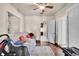 Cozy bedroom with hardwood floors, ceiling fan, natural light, and closet space at 7060 Holly St, Commerce City, CO 80022