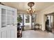 Dining area featuring a stylish chandelier, with a window view of the backyard at 7060 Holly St, Commerce City, CO 80022
