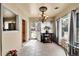 Bright dining area featuring tile flooring, a stylish chandelier, and ample natural light at 7060 Holly St, Commerce City, CO 80022