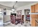 Charming kitchen featuring a dining area, wooden cabinets and stainless steel appliances at 7060 Holly St, Commerce City, CO 80022