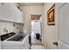 Laundry room with appliances, cabinets and access to other parts of the home at 7060 Holly St, Commerce City, CO 80022