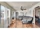 Comfortable living room with hardwood floors, fan and natural light at 7060 Holly St, Commerce City, CO 80022