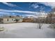 Snowy backyard featuring a wooden fence offering privacy at 2332 W Baltic Pl, Englewood, CO 80110