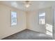 Bright bedroom with two windows and neutral carpeting at 2332 W Baltic Pl, Englewood, CO 80110