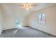 Spacious bedroom with carpeted floors, two windows, and a ceiling fan at 2332 W Baltic Pl, Englewood, CO 80110