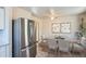 Bright dining area with modern table set and stainless steel refrigerator at 2332 W Baltic Pl, Englewood, CO 80110