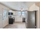 Well-lit kitchen with white cabinets and stainless steel appliances at 2332 W Baltic Pl, Englewood, CO 80110
