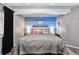 Well-lit bedroom boasting blue walls, a comfortable bed, and a large window at 4819 Jericho Ct, Denver, CO 80249