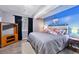 Charming bedroom featuring a blue accent wall, comfortable bed, and ample natural light at 4819 Jericho Ct, Denver, CO 80249