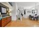 Well-lit dining and living space featuring hardwood floors and convenient access to other living areas at 4819 Jericho Ct, Denver, CO 80249