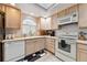 Well-lit kitchen featuring a range of appliances, plenty of counter space, and a window above the sink at 4819 Jericho Ct, Denver, CO 80249