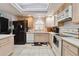 Bright kitchen with appliances, tiled floor, a large window, and ample counter space at 4819 Jericho Ct, Denver, CO 80249