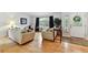 Bright living room featuring hardwood floors, large windows, and comfortable seating, creating a welcoming atmosphere at 4819 Jericho Ct, Denver, CO 80249