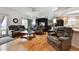 Cozy living room with leather furniture, hardwood floors, and a ceiling fan for added comfort at 4819 Jericho Ct, Denver, CO 80249