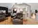 Bright, open-concept living area featuring hardwood floors, modern lighting, and a neutral color scheme at 4819 Jericho Ct, Denver, CO 80249