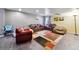 Spacious living room featuring leather sofas, cozy beanbag chairs, and a patterned rug at 4819 Jericho Ct, Denver, CO 80249